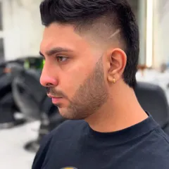 It's all about the details in men's grooming. Here's a look at a sharp, modern fade with a precise design line, showcasing our skill in creating clean, stylish, and personalized haircuts for men.