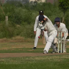 A classic on-drive captured during a competitive practice match. Our players are trained in real-game situations, complete with umpires and wicketkeepers, to prepare them for the pressures of a formal match.