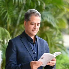 A candid-style shot of the author reading his own book. This type of photo helps to build a connection between the author and their work.