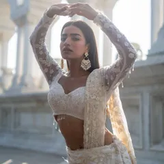Another piece from our Ivory Edit. This full-sleeve sheer blouse with delicate embroidery is part of a stunning lehenga set.