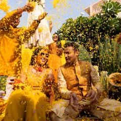 The pure joy of a Haldi ceremony, with the couple showered in yellow flower petals. My goal is to create a backdrop that enhances these happy, candid moments.