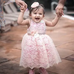 This is the smile that makes it all worthwhile. This little one is radiating pure joy in her custom pink lace dress, featuring delicate floral appliqués and a comfortable fit perfect for taking her first wobbly steps. It’s more than a dress; it’s a memory of pure happiness.