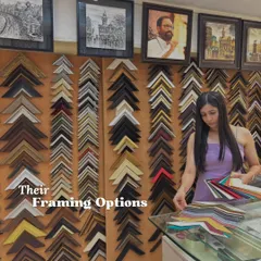 The journey of a bespoke frame begins with choice. Here, our curator assists a client in navigating our extensive collection of over 100 acid-free mount options, ensuring the perfect color and texture to complement their art.