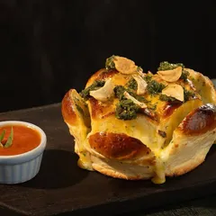 Meet my Cheesy Pull-Apart Bread. It's loaded with gooey cheese, crispy garlic, and fresh herbs, served with a side of rich marinara. It’s the perfect starter to get the party going.
