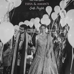 A black and white shot of the couple's entry at their Sufi night, with guests holding up balloons to create a dreamy pathway. Rumi would approve.