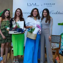 We provided the decor for this "Conversation over Cocktails" event. The large tropical plants and floral arrangements created a sophisticated and lush backdrop for the stage.