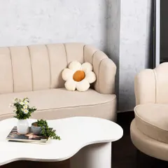 Our lounge area features a beautiful beige fluted sofa and a unique coffee table, creating a chic, ready-to-shoot corner for lifestyle content or client meetings.