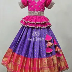 A similar tiered design with a ruffled peplum top. The bright pink blouse and purple skirt create a festive look, perfect for a little girl who loves to twirl.
