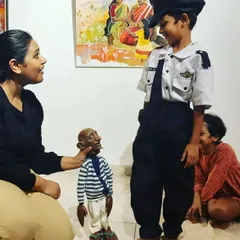 I'm introducing our 'Popo' thatha puppet to a young boy dressed as a pilot. These audience interactions are often the most memorable parts of a show.