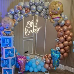 This 'Oh! Baby' setup is perfect for a modern baby shower. It features a balloon ring in metallic silver, rose gold, and blue, with baby-themed foil balloons and 'BABY' display boxes.