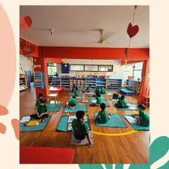 A wide view of our classroom shows children engaged in various activities. Some work alone, others in small groups, but all are learning with purpose and joy.
