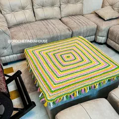 The square table mat shown in its home setting. It demonstrates how a custom crochet piece can tie a room together and add personality.