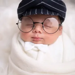 A dapper little gentleman! This close-up shot highlights the adorable details of this themed pose, from the tiny white bowtie to the round glasses.