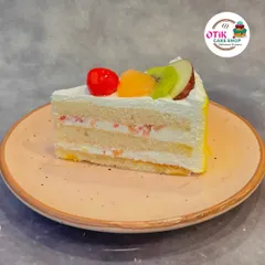Our Fresh Fruit Pastry is a light and refreshing choice. This slice features layers of vanilla sponge, fresh cream, and a mix of seasonal fruits, offering a taste of pure, simple goodness.