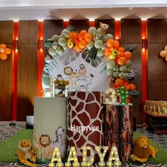 A stylish take on the jungle theme for Aadya's birthday. I used giraffe and tree bark print pedestals, a leafy backdrop, and marquee letters to create a chic safari vibe.