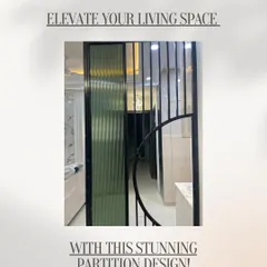 Partitions can be both functional and beautiful. This design uses fluted glass and a black metal frame with a circular accent to elegantly divide the living space while allowing light to pass through.