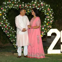 Celebrating 25 years of love. We created this beautiful outdoor photo spot with a heart-shaped floral arch and large, illuminated "25" marquee numbers.