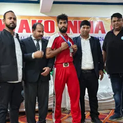 A team member proudly displaying his medal at the National Kickboxing Championships in Jaipur. A testament to his hard work.