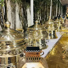My collection of ornate, polished brass chafing dishes and serveware. I believe the presentation is just as important as the taste, and this setup adds a touch of royalty to any buffet line.