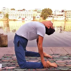 Ustrasana, the Camel Pose, is a deep backbend that opens the entire front of the body, including the chest and heart center. Practiced by the water's edge, it reminds us that the results of a proper *sadhana* (practice) are as certain as a scientific experiment.