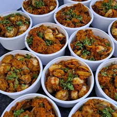 These are fresh cockles, or 'khube', cooked in a delicious Goan sukka masala. This dish is a Saturday special that often sells out quickly, a testament to its irresistible flavor.