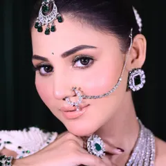 A side profile of this modern bride, showcasing the sharp, defined eye makeup and the way the diamond jewelry complements the cool tones in the makeup. The skin is smooth and matte, perfect for a Nikaah or reception look.