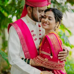 A sweet embrace between the happy couple. The bride's radiant smile and glowing skin are the focus of this beautiful memory.