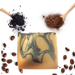 A beautiful shot of my Charcoal Coffee cold-process soap, swirled with activated charcoal and surrounded by coffee beans. This bar is a customer favorite for its ability to gently exfoliate and detoxify the skin, leaving it feeling energized and clean.
