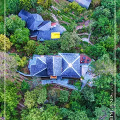 Our architectural work aims to harmonize with its surroundings. This aerial drone view shows the Blushing Pines Retreat in Bhowali, Uttarakhand, nestled seamlessly into the lush green hillside, demonstrating how thoughtful design can respect and enhance nature.