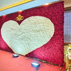 Nothing says "love" quite like a wall of roses. This floor-to-ceiling floral backdrop, featuring a giant heart of white blooms set against a sea of red, creates an incredibly powerful and romantic focal point for any wedding or engagement celebration.