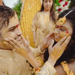 A playful moment during Medhus and Adi's Haldi, as they lovingly apply turmeric to each other's faces. These are the fun, candid memories that make a wedding film special.