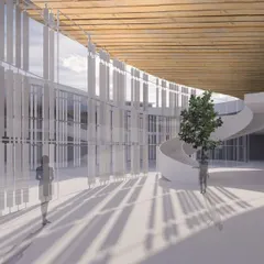 A rendering of the reception area for a 600,000 sq. ft. campus in Pune. The space is flooded with natural light from expansive glass windows, while a signature spiral staircase and a life-size car on the wall signal a future that is electric.