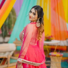 A close-up portrait in the pink lehenga, showing off the detailed blouse and earrings. I focus on the complete look, from the outfit to the accessories.