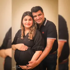 A classic couple's portrait from an indoor maternity session. The focus is simply on the two of you, holding onto this moment just before you become three.