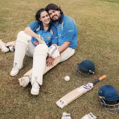 A moment of rest and connection amidst the cricket gear. This photo shows the couple's relaxed and happy chemistry, even when surrounded by bats and balls.