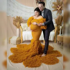 For the mama who wants to celebrate her beautiful bump, this mustard yellow mermaid gown is a showstopper. The fitted silhouette and dramatic ruffled train create a powerful and glamorous look for any maternity photoshoot.