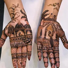A clear, well-lit shot of a modern scenic mehandi design. The bold lines and artistic composition with peacocks and domes make this a very popular style.