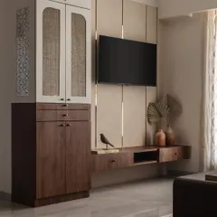 We designed this TV unit to be both a focal point and a functional storage solution. The combination of wood, beige fabric panels, and rattan cabinet doors creates a warm, textured look.
