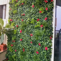A detailed look at an artificial vertical garden setup. I mix different types of artificial leaves, grasses, and flowers to create a rich texture and a natural look. This is a popular choice for modern apartments in Bangalore.