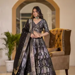 Showcasing a stunning black and silver Banarasi lehenga. The lighting is set to capture the metallic sheen of the brocade work, emphasizing the luxurious feel of the outfit.