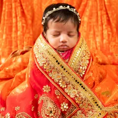 A deeply personal portrait of an 18-day-old baby girl wrapped in her mother's ornate orange and gold wedding saree. I love incorporating family heirlooms into my sessions.