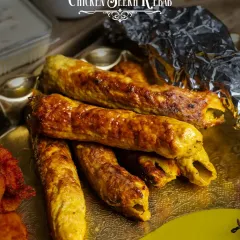Juicy Chicken Seekh Kebabs, as featured in our Akbari Thaal. These kebabs are minced, spiced, and grilled to perfection, offering a smoky flavor and a tender bite.