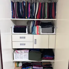 My goal is to make sure you can see and enjoy every single piece of clothing you own. Here, we've used hanging organizers for pants and open bins for folded items, ensuring nothing gets lost at the back of the shelf.