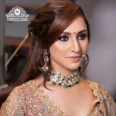 A close-up of a bold and beautiful look. This features a dark smokey eye and a nude lip, paired with traditional jewellery for a fusion style perfect for a reception.