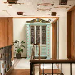 This custom bar cabinet was designed as a centerpiece for a landing. Inspired by Chettinad architecture, it features stained glass panels and a playful colour palette of mint green and ochre, making it a joyful and nostalgic statement piece.