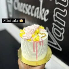 A hand-held view of the mini cake, showing its petite and personal size.