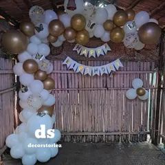 We decorated this rustic bamboo hut for a birthday party using a white and gold balloon arch. The 'Happy Birthday' banner and butterfly details complete the charming and celebratory look.