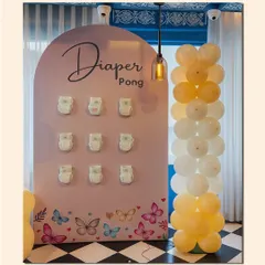 It's not a baby shower without some fun. We designed this custom "Diaper Pong" game station, complete with a themed backdrop and matching balloon decor, to get guests laughing and mingling.