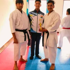 An instructor receiving a well-deserved award for his performance, standing with me and another senior instructor. We celebrate success at every level.