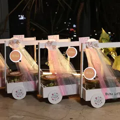 I had so much fun creating these luxury baby shower carts for a celebration in Gurgaon. Each custom white basket on wheels was filled with premium goodies like lemon masala makhanas, Theobroma cookies, and a ceramic bonsai planter to delight every guest.